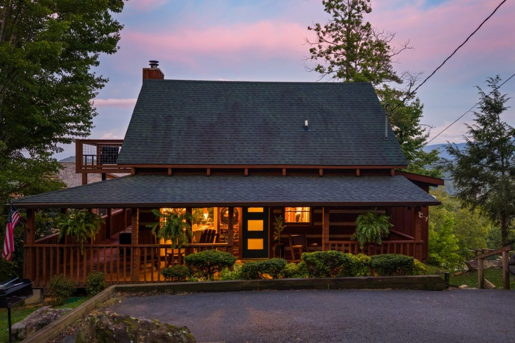 Dancing Embers cabin exterior glowing at twilight
