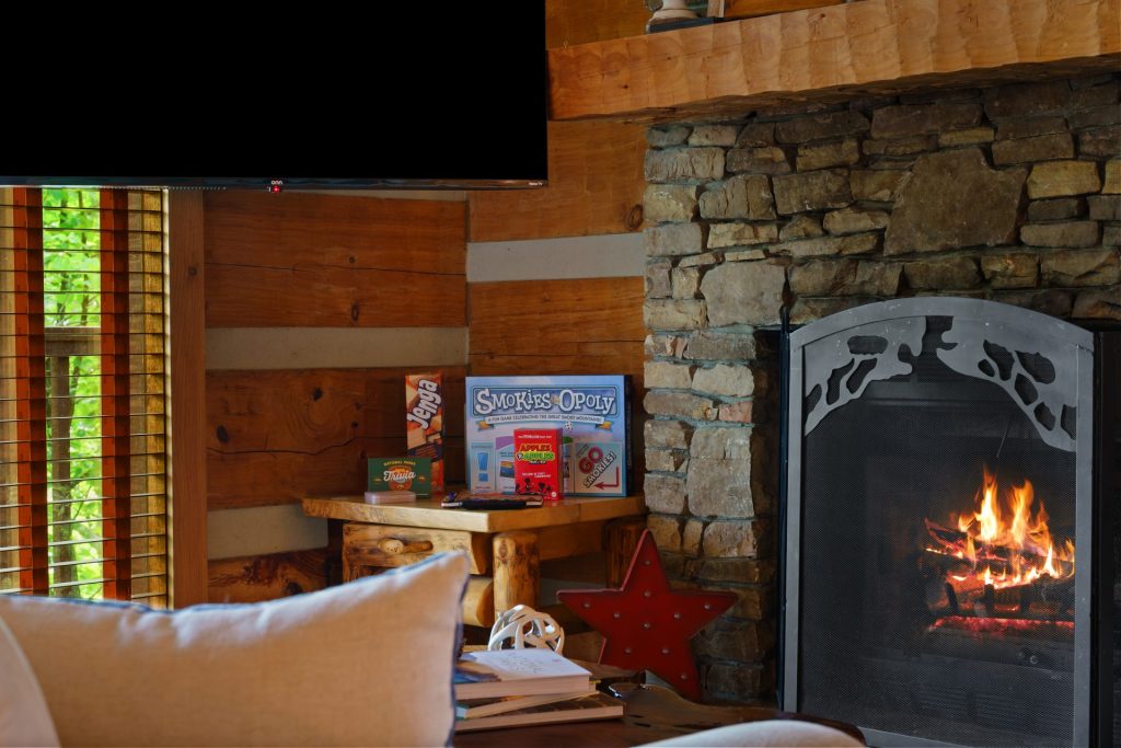 Living room fireplace with TV at Dancing Embers cabin, Sevierville, TN