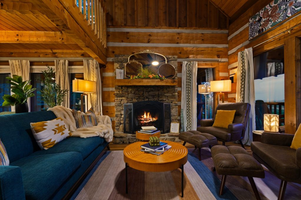 Living room fireplace with blue sofa at Dancing Embers cabin