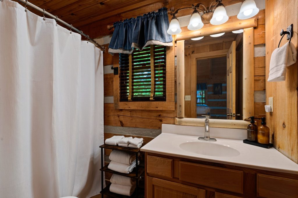 Bathroom vanity with towels at Nestled Oaks cabin