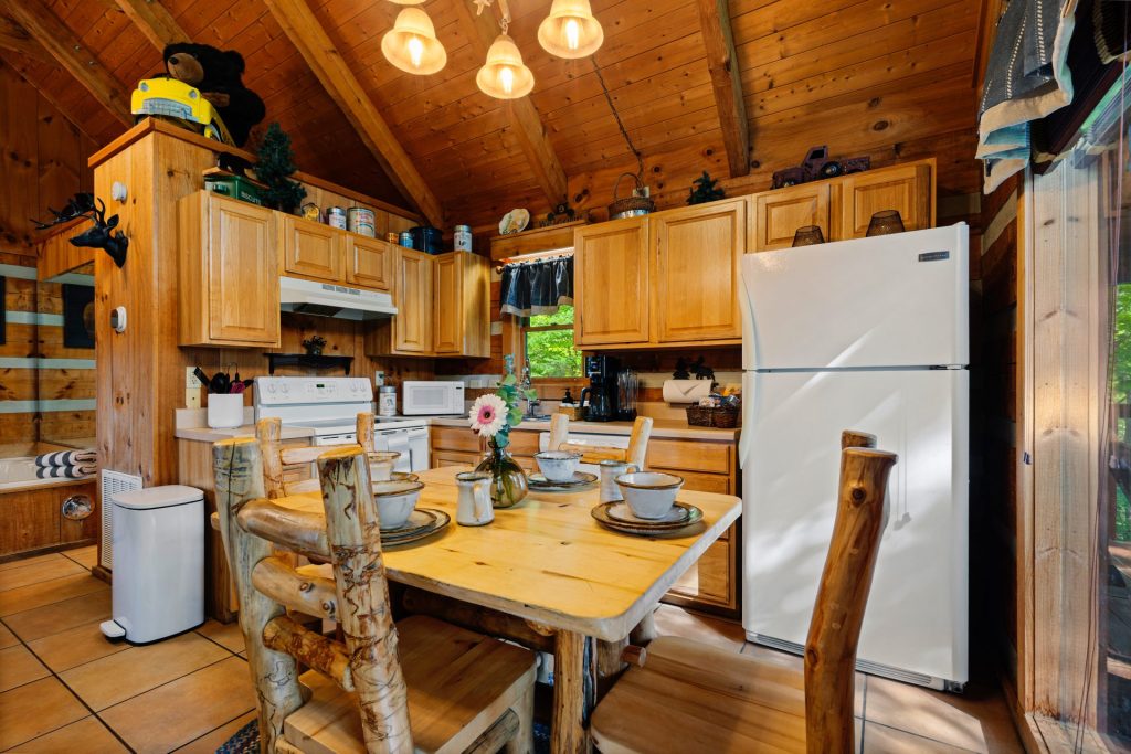 Alternate view of kitchen and dining area at Nestled Oaks cabin