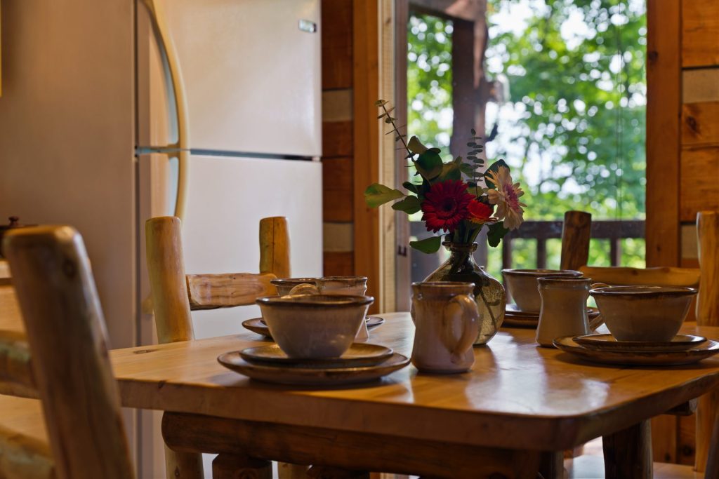 Close-up of dining table with flowers at Nestled Oaks cabin