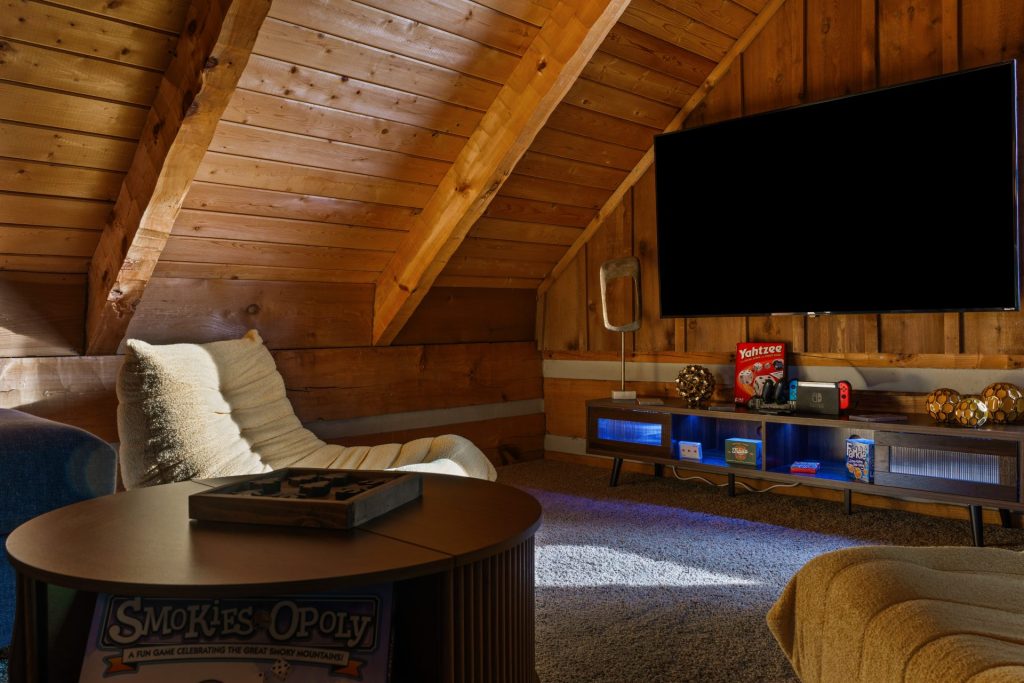 Loft lounge with media area and games at Dancing Embers cabin
