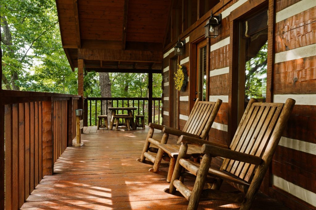 Porch rocking chairs and walkway at Nestled Oaks cabin